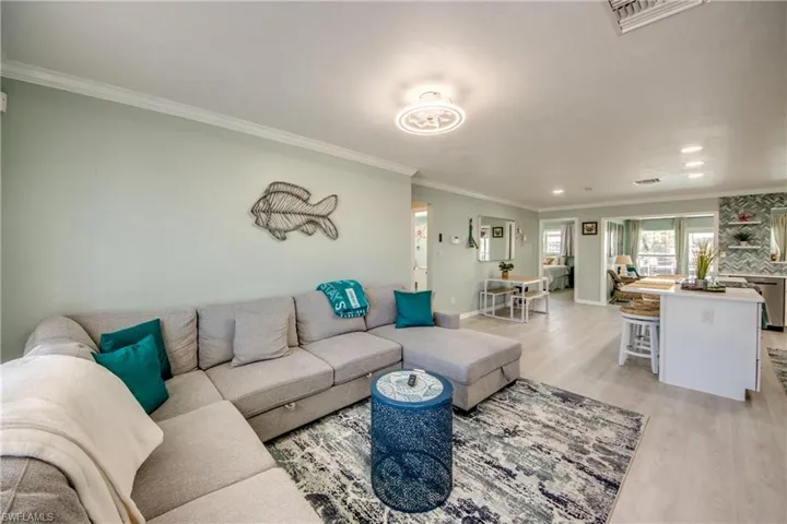 Living room featuring light hardwood / wood-style flooring and ornamental molding