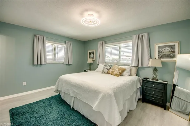 Bedroom with a textured ceiling and light wood-type flooring