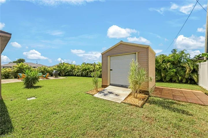 Fenced yard with a patio and a storage shed