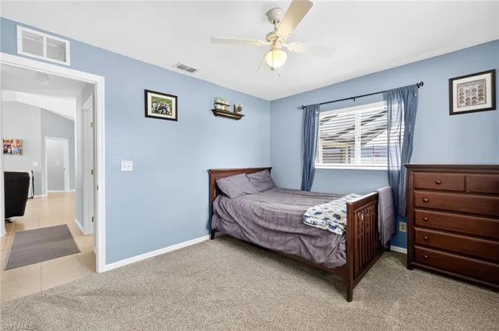 Bedroom featuring light carpet and a ceiling fan