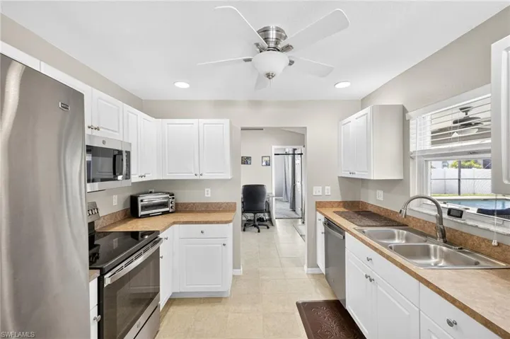 Kitchen featuring appliances with stainless steel finishes, a ceiling fan, recessed lighting, and white cabinets