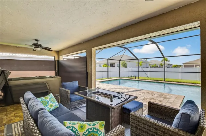View of Lanai w/ Fire Pit, Spa, with outdoor lounge area, a ceiling fan, and glass enclosure