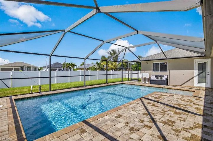View of pool with a patio and screen enclosure