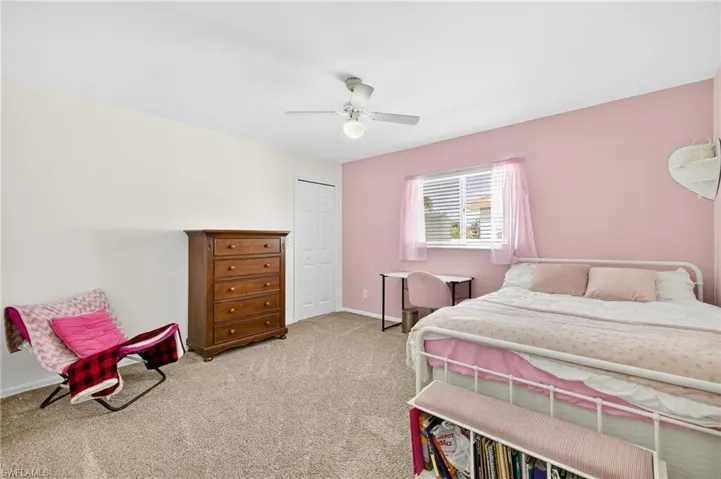Bedroom featuring carpet, a closet, and a ceiling fan