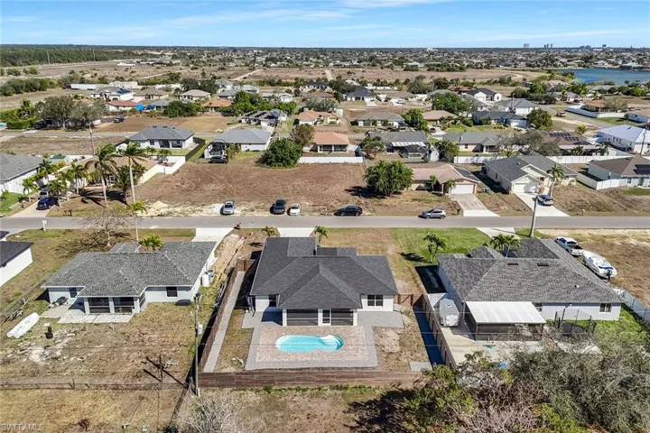 Aerial view of residential area featuring a pool