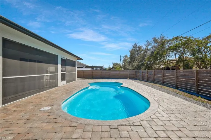 View of pool with a fenced backyard and patio surround