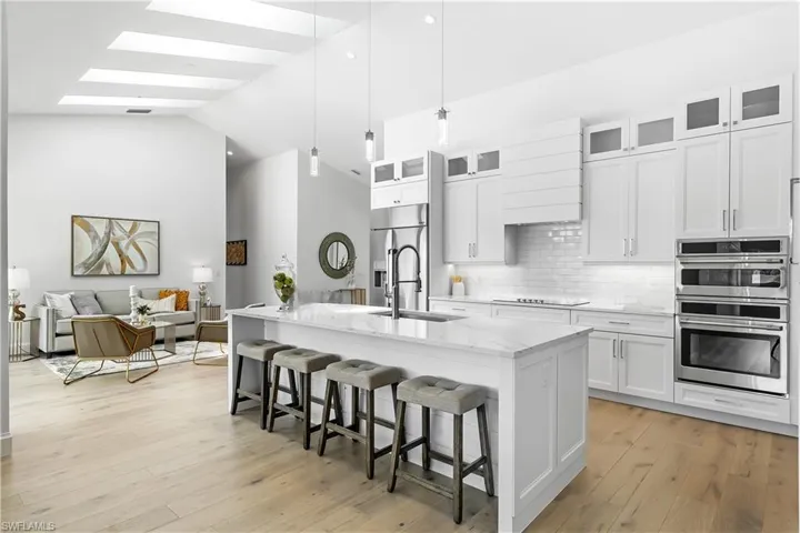 Quartz Countertops, Tile Backsplash, Pendant & Under-Cabinet Lighting.