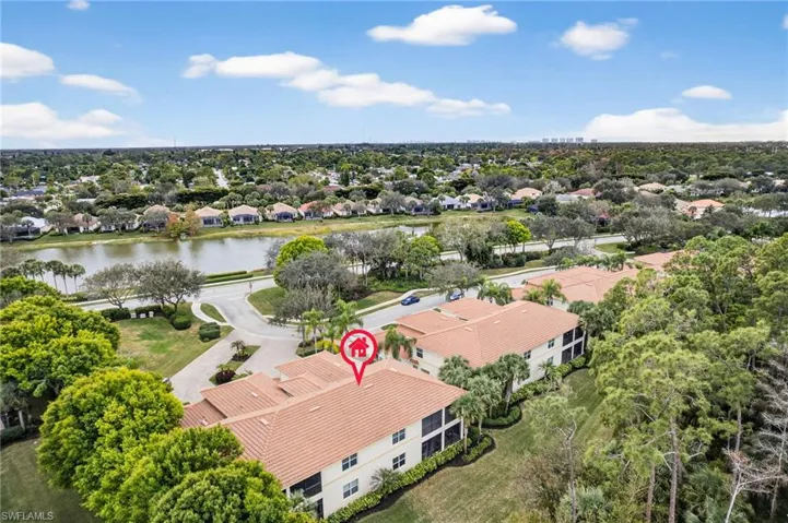 Aerial view of residential area featuring a large body of water