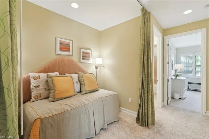 Carpeted bedroom with baseboards and recessed lighting