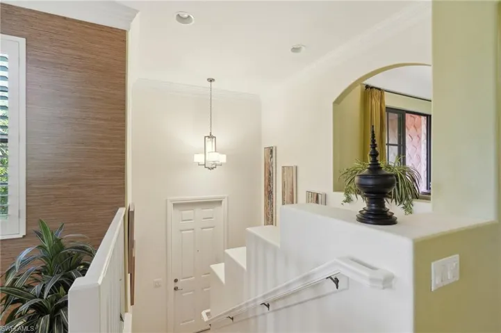 Stairs with arched walkways and ornamental molding