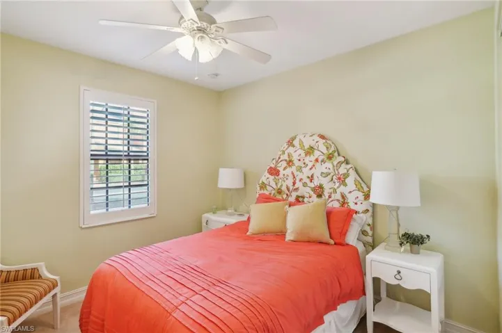 Bedroom with baseboards, ceiling fan, and carpet