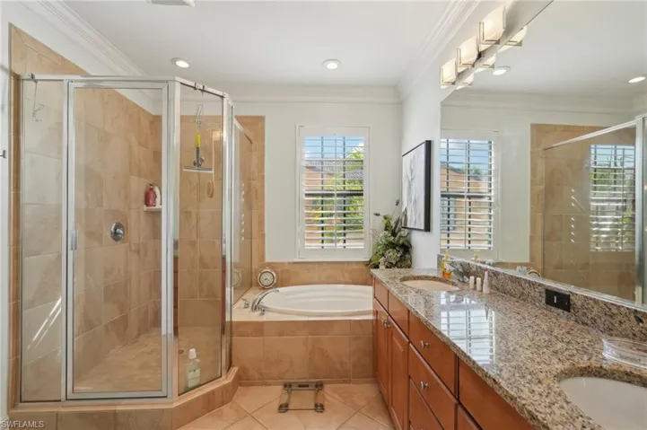Bathroom with tile patterned flooring, a sink, a bath, and a shower stall