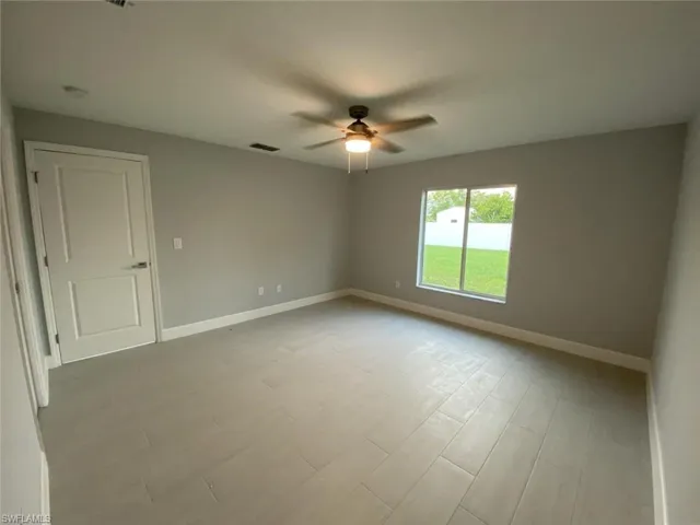 Empty room with ceiling fan and light hardwood / wood-style flooring
