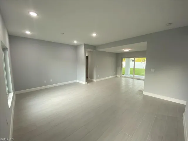 Empty room with light hardwood / wood-style flooring