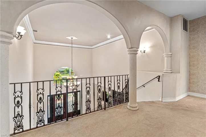 Second floor arches, wrought iron railing and outstanding view of the foyer