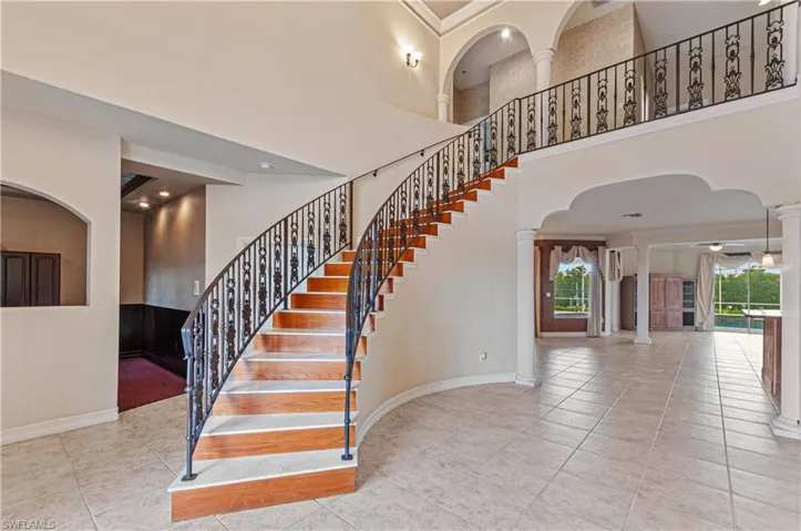 Stairway with wrought iron details, pillars and arches