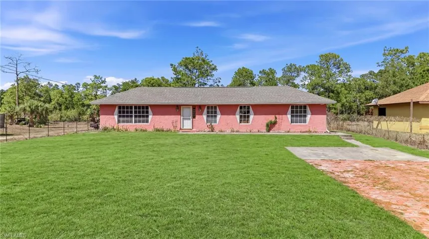 Ranch-style house featuring roof with shingles and stucco siding