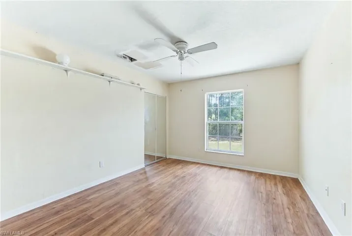 Virtually Unfurnished 2nd bedroom with wood finished floors and a ceiling fan