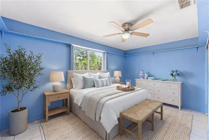 Virtually staged 3rd Bedroom featuring light tile patterned floors and a ceiling fan
