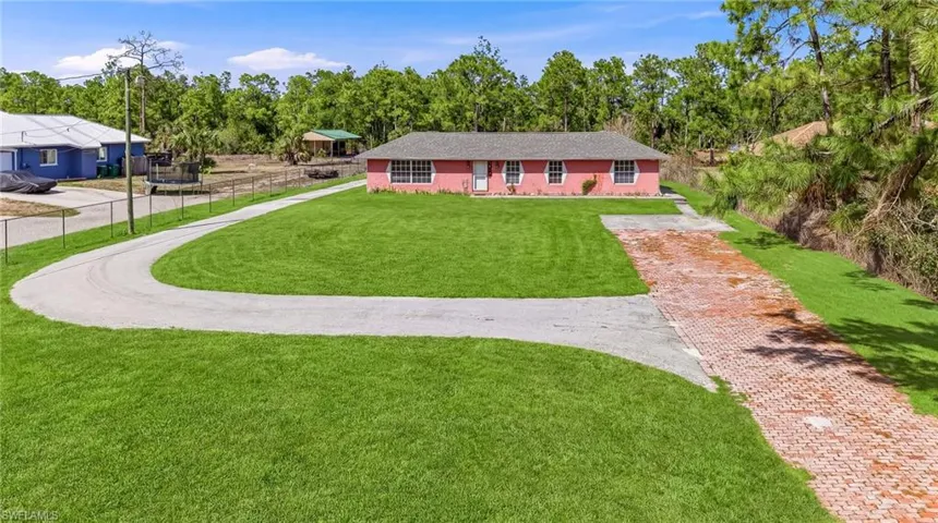 View of front of property with a front lawn and driveway