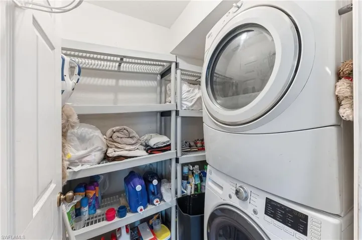 Laundry room featuring stacked washer and dryer