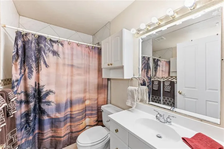 Full bathroom featuring vanity and curtained shower