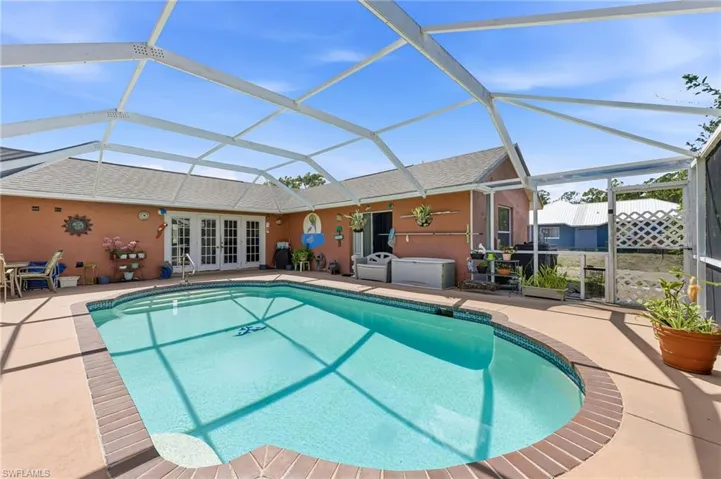 Swimming pool with screen enclosure.