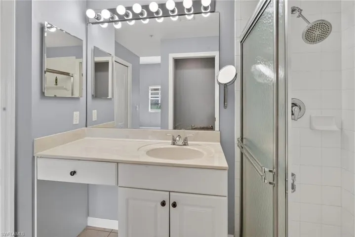 Vanity with integrated sink and chrome faucet, under-counter storage, and dedicated knee space
