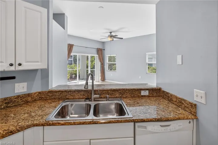 Kitchen area featuring a double basin stainless steel sink with a gooseneck faucet