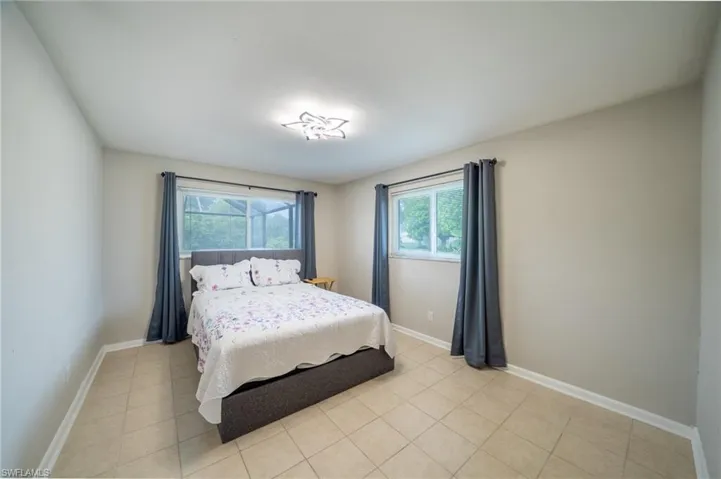 Bedroom featuring baseboards and light tile patterned floors