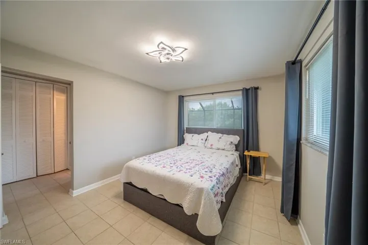 Bedroom with light tile patterned floors