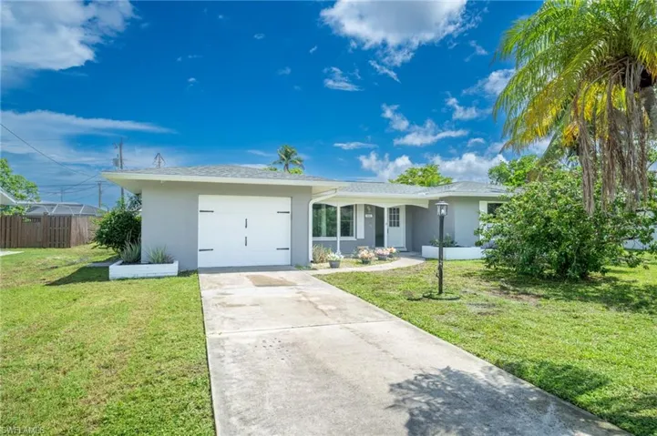 Ranch-style home with stucco siding, a garage, and concrete driveway
