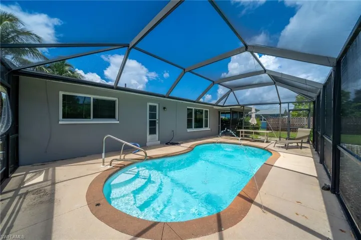 Outdoor pool with a patio and a lanai