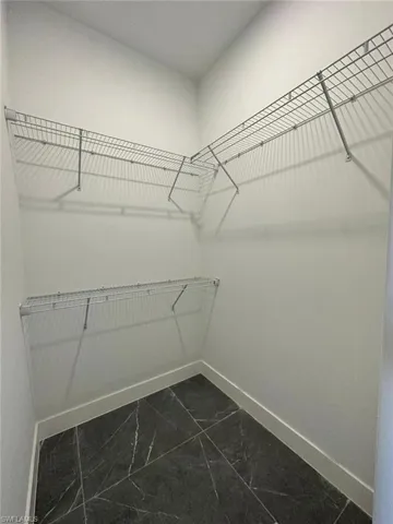 Spacious closet with marble finish floor