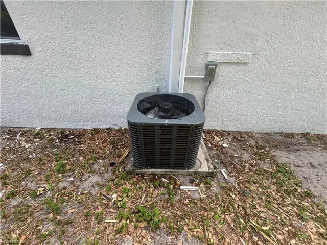 Details with central air condition unit and stucco siding