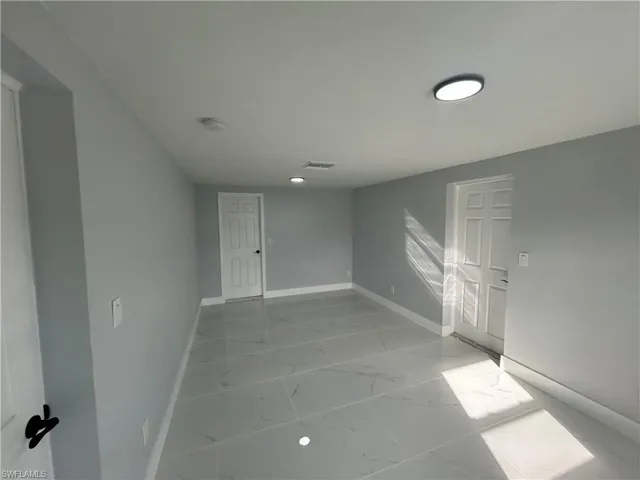 Empty room with marble finish floor and baseboards