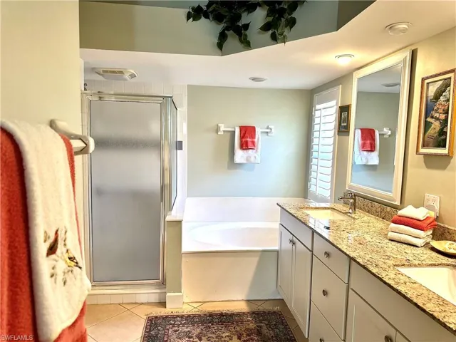 The main en suite bath which features separate bath tub, step in shower, and a water closet for privacy.