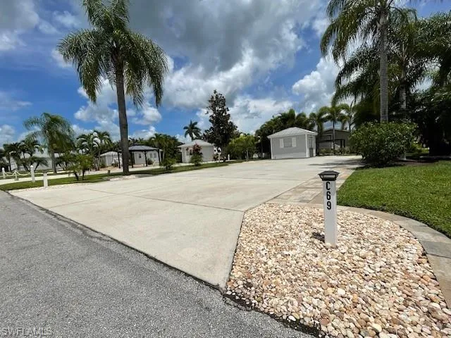 View of front facade featuring a garage and an outdoor structure