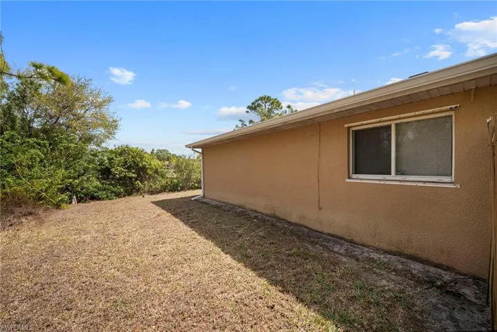 View of side of home featuring stucco siding