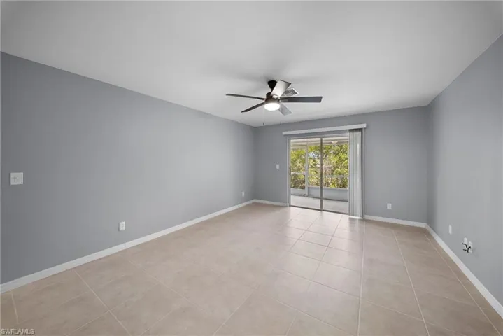 Spare room featuring ceiling fan and light tile patterned flooring