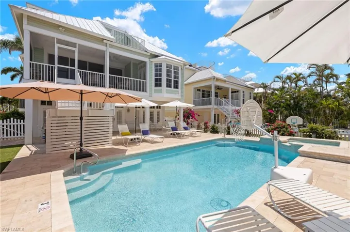 View of swimming pool with stairway, a patio, a sunroom, a pool with connected hot tub, and a ceiling fan