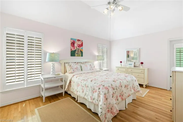 Bedroom featuring light wood-style flooring, baseboards, and ceiling fan