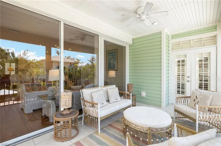 Wooden terrace featuring ceiling fan, an outdoor living space, and french doors