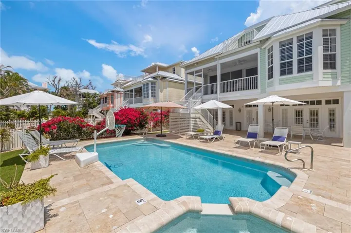 View of swimming pool with stairway, a patio area, french doors, and a sunroom