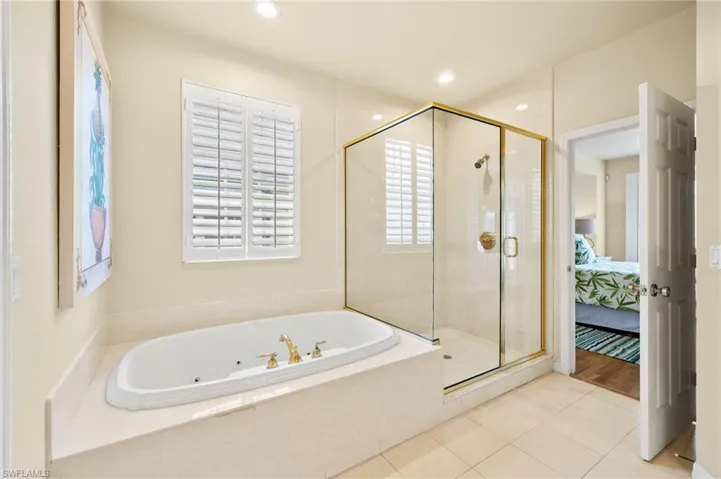 Full bathroom with a whirlpool tub, a shower stall, connected bathroom, tile patterned flooring, and recessed lighting