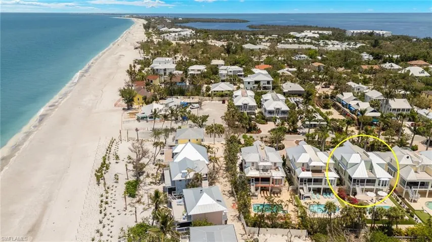 Aerial view of residential area featuring unending shoreline