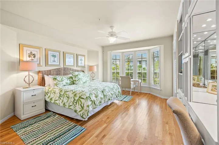 Bedroom featuring multiple windows, baseboards, light wood finished floors, and recessed lighting