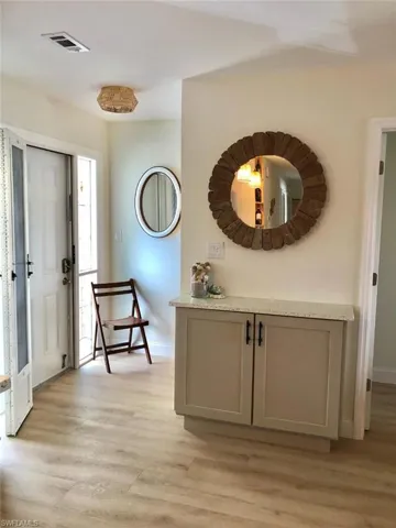 Entryway with light wood-style flooring and baseboards