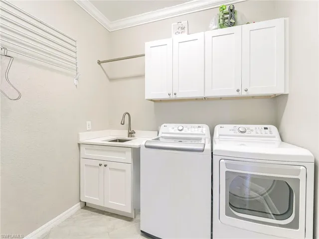 Additional storage and full size sink add to the utility of the laundry room