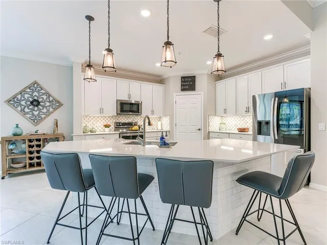 Amazingly large one level modern style island with Quartz counters.